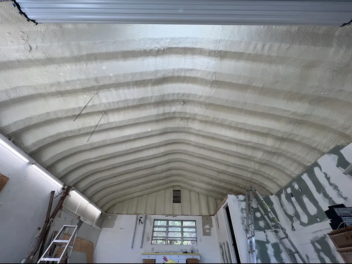Spray polyurethane foam applied to the underside of a metal roof deck in The Crossings